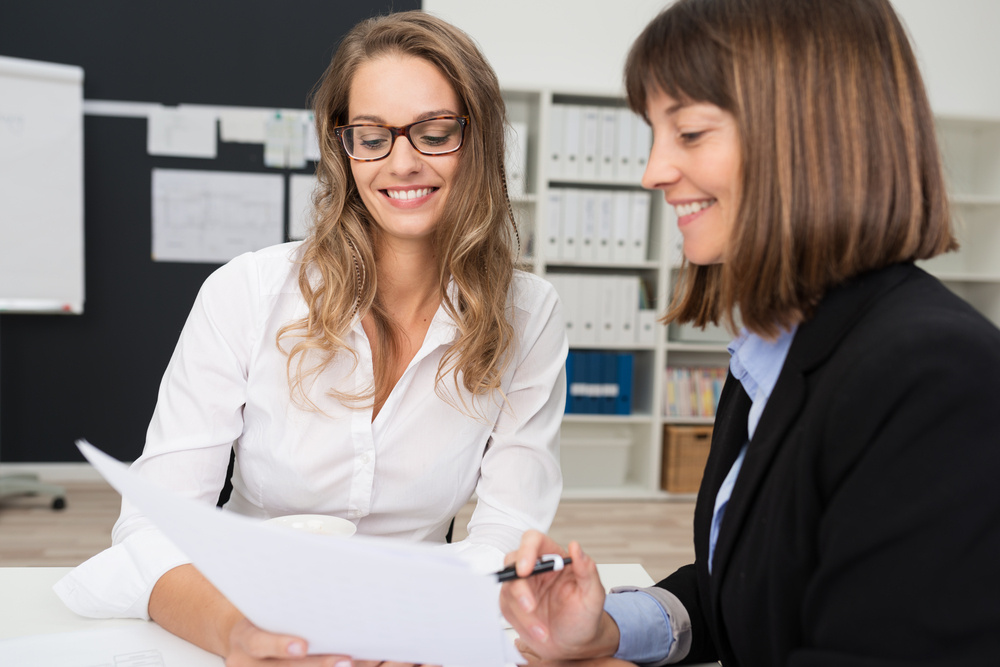 Close up Two Happy Young Businesswomen at the Office Talking About Business Report on Paper.-4