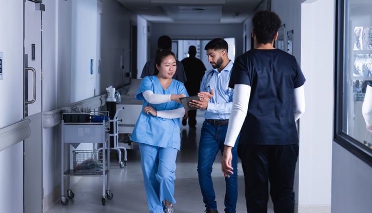 Deskless workers in healthcare collaborating with mobile devices to stay connected and improve productivity.