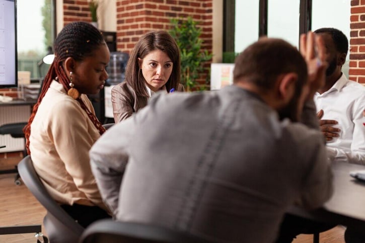 Equipo de dirección revisando estrategias durante una reestructuración empresarial.