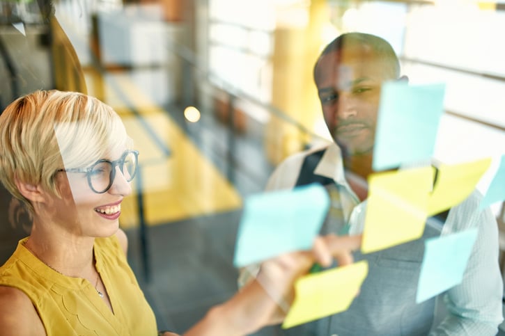 managers developing culture strategy on board with sticky notes