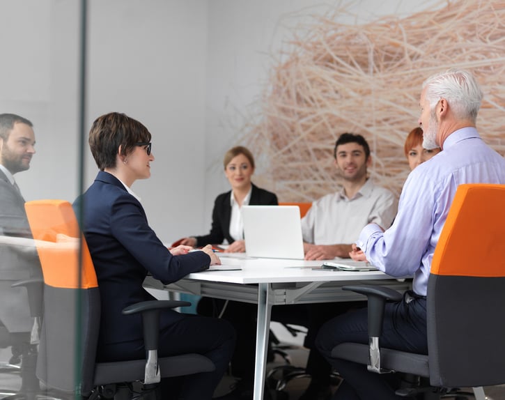 business people group on meeting at modern bright office indoors. Senior  businessman as leader in discussion.