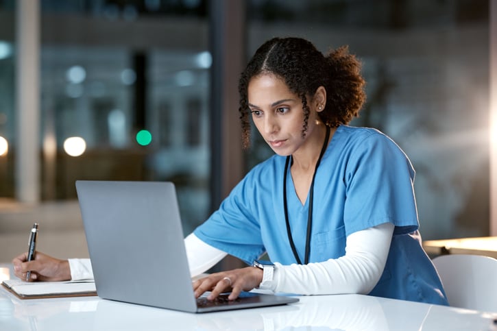 PRN employee reviewing patient records at a healthcare facility