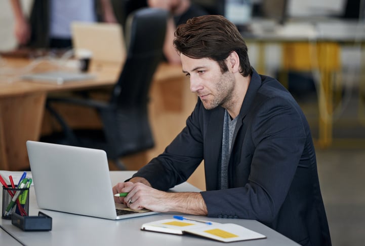 employee working on project on laptop