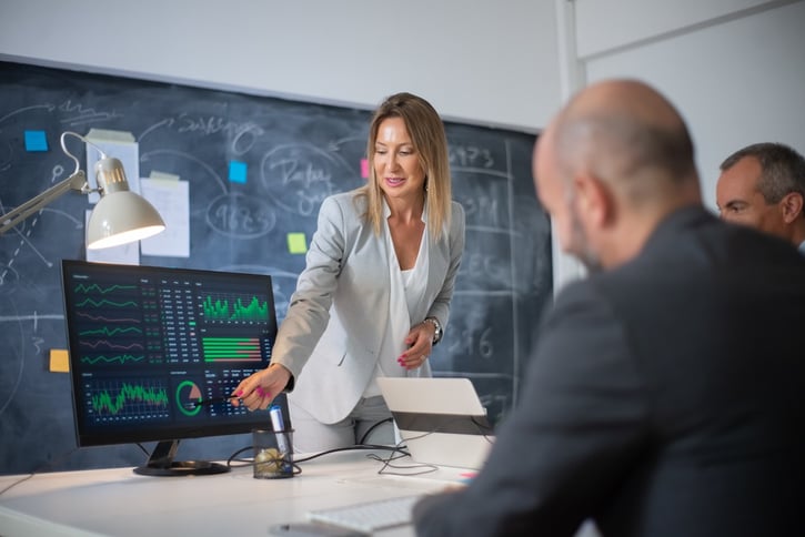 HR managers looking at HR analytics on computer screen