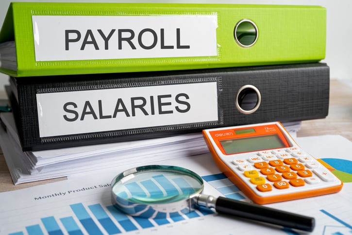 payroll and salary binders on desk symbolising semi monthly payroll managament