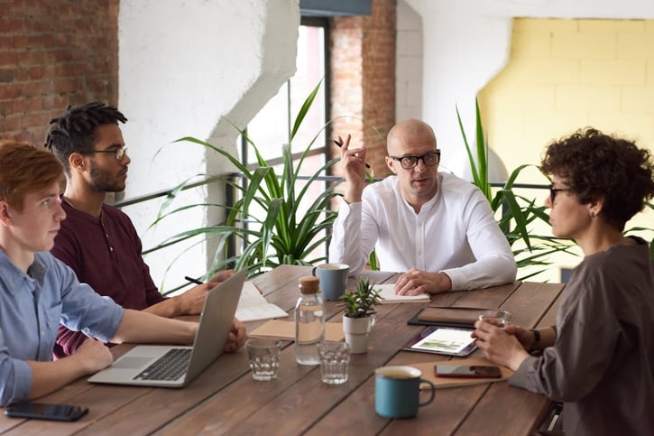 Mitarbeiter diskutieren den Ressourcenplan im Büro.