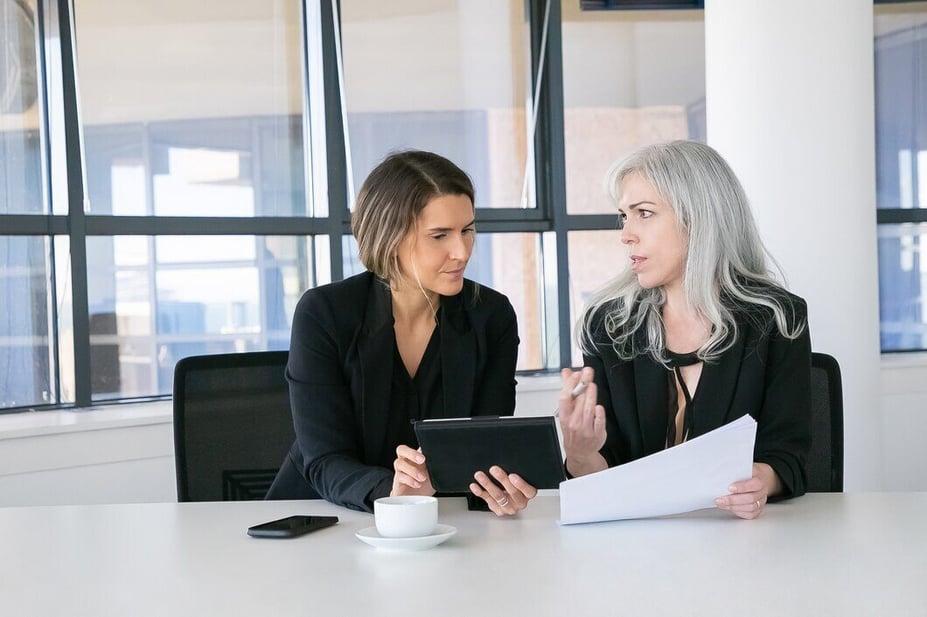 Team of professionals discussing the average number of work days in a month