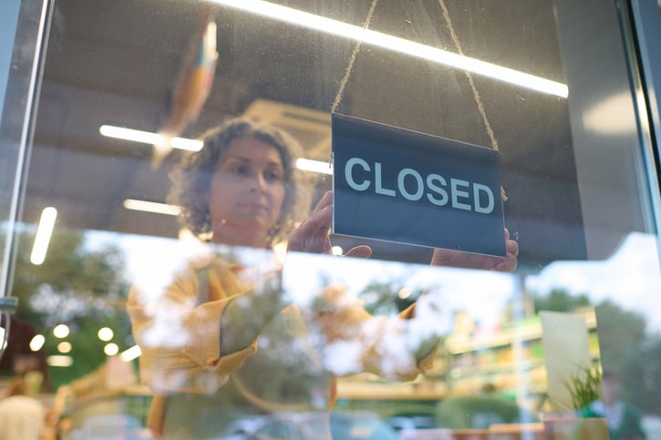 sales woman closing shop after shift symbolising clopening shift